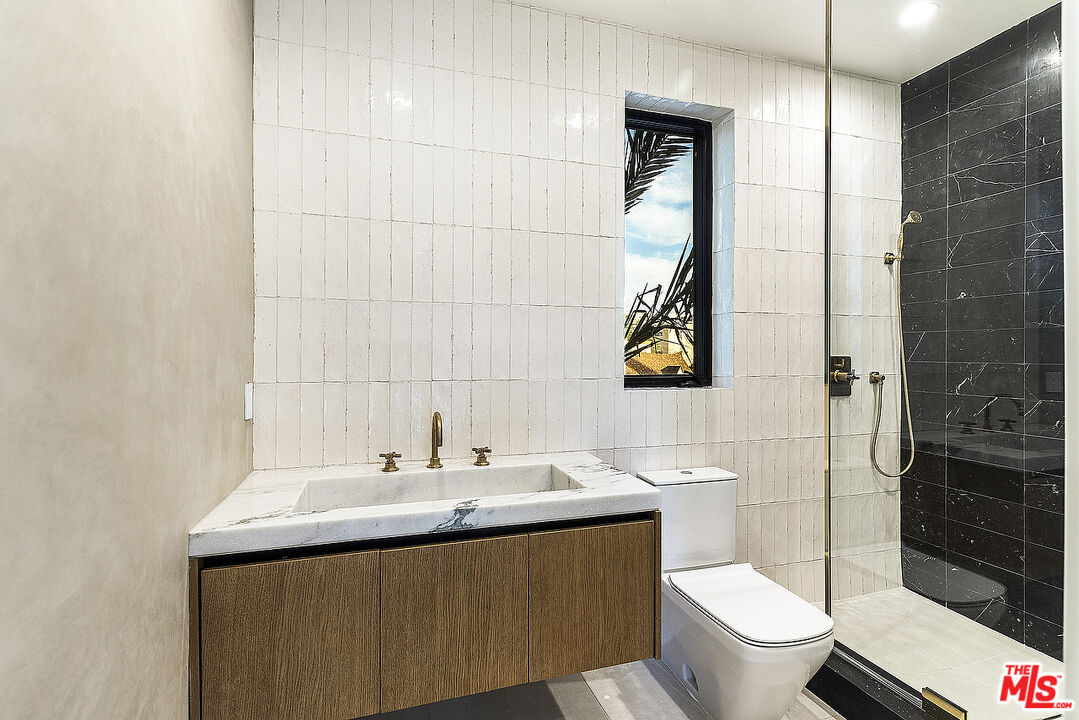 8566 Colgate Avenue Los Angeles, CA 90048 - Photo 16 of 22 a bathroom with a sink toilet and shower