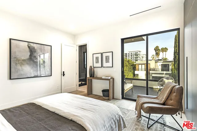 a bedroom with a bed and glass windows