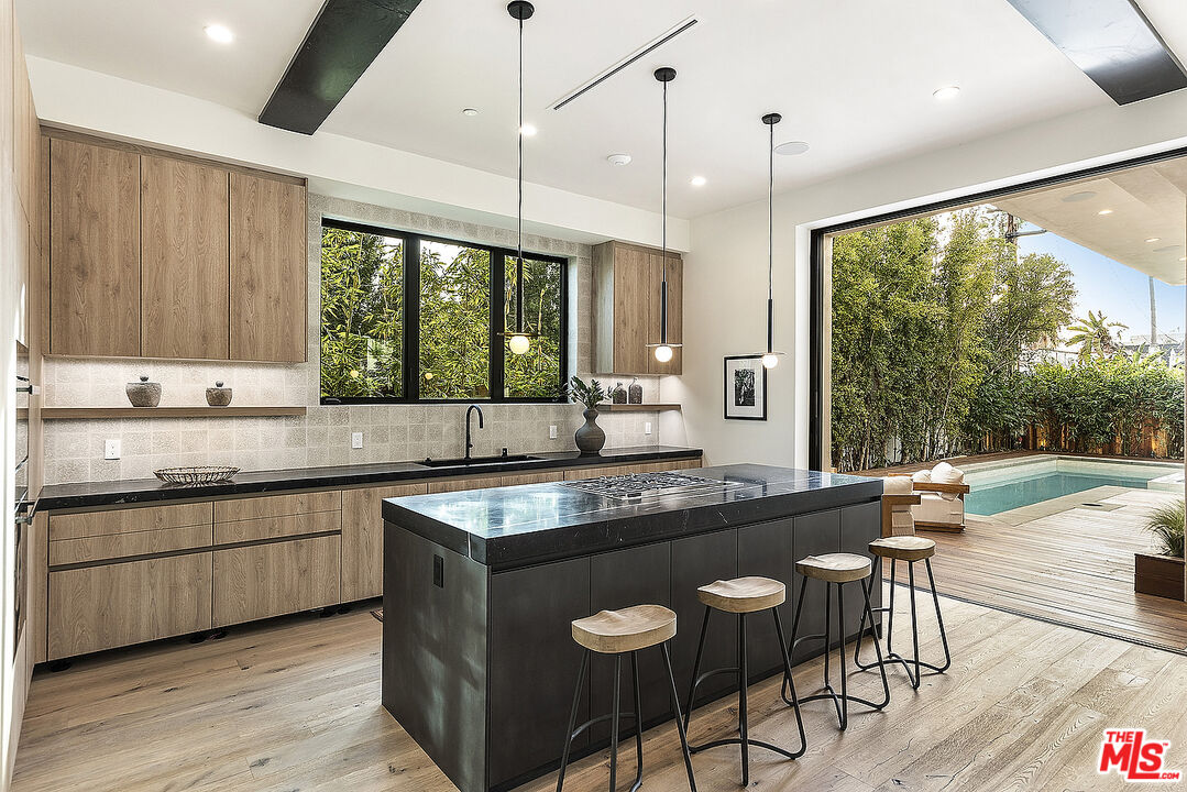 8566 Colgate Avenue Los Angeles, CA 90048 - Photo 6 of 22 a kitchen with stainless steel appliances granite countertop a stove a sink and a wooden cabinets
