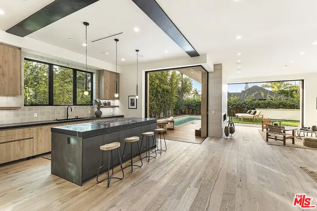 a kitchen with a stove sink and wooden floor