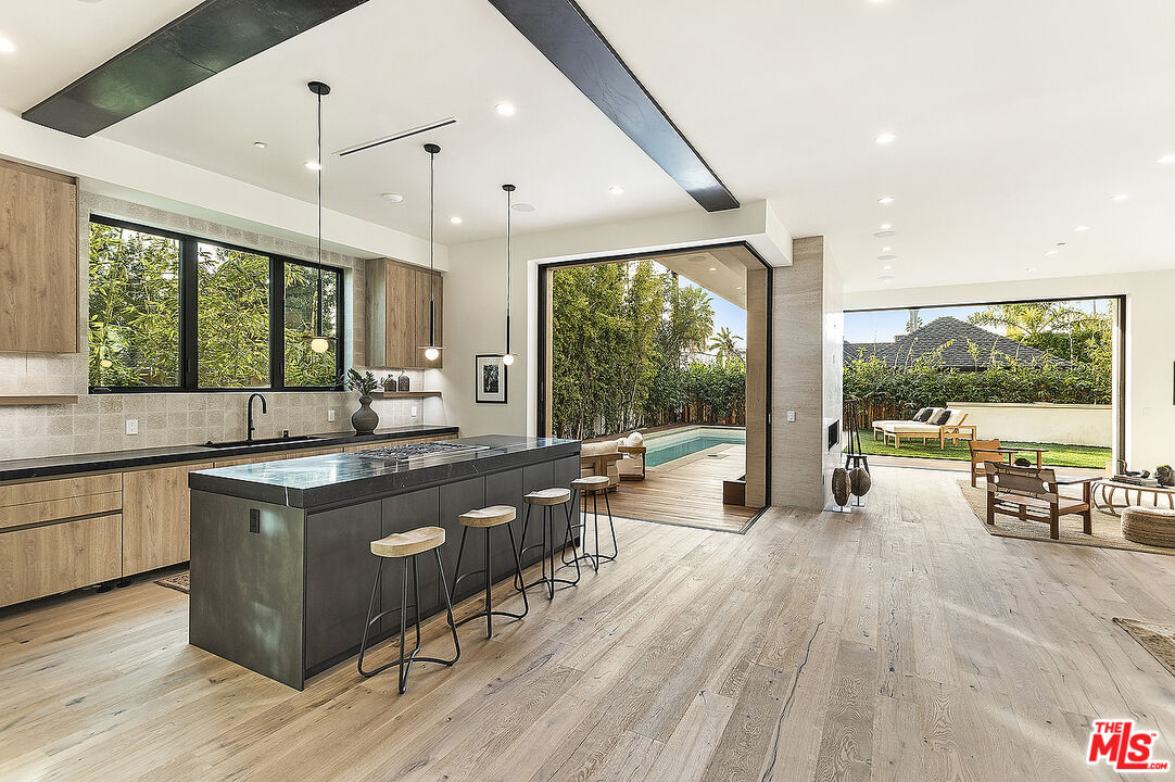 8566 Colgate Avenue Los Angeles, CA 90048 - Photo 7 of 22 a kitchen with a stove sink and wooden floor