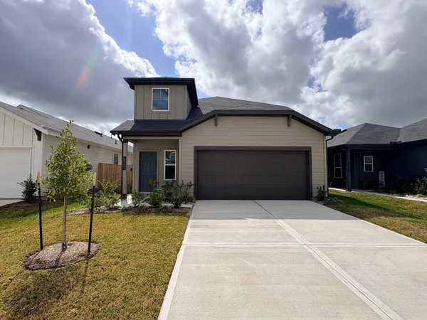 a front view of a house with a yard and garage
