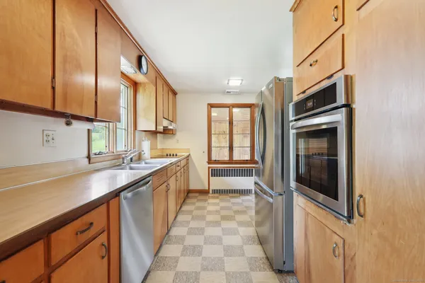 a kitchen with stainless steel appliances a sink stove and cabinets