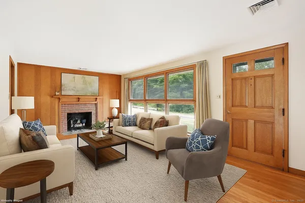 a living room with furniture and a fireplace