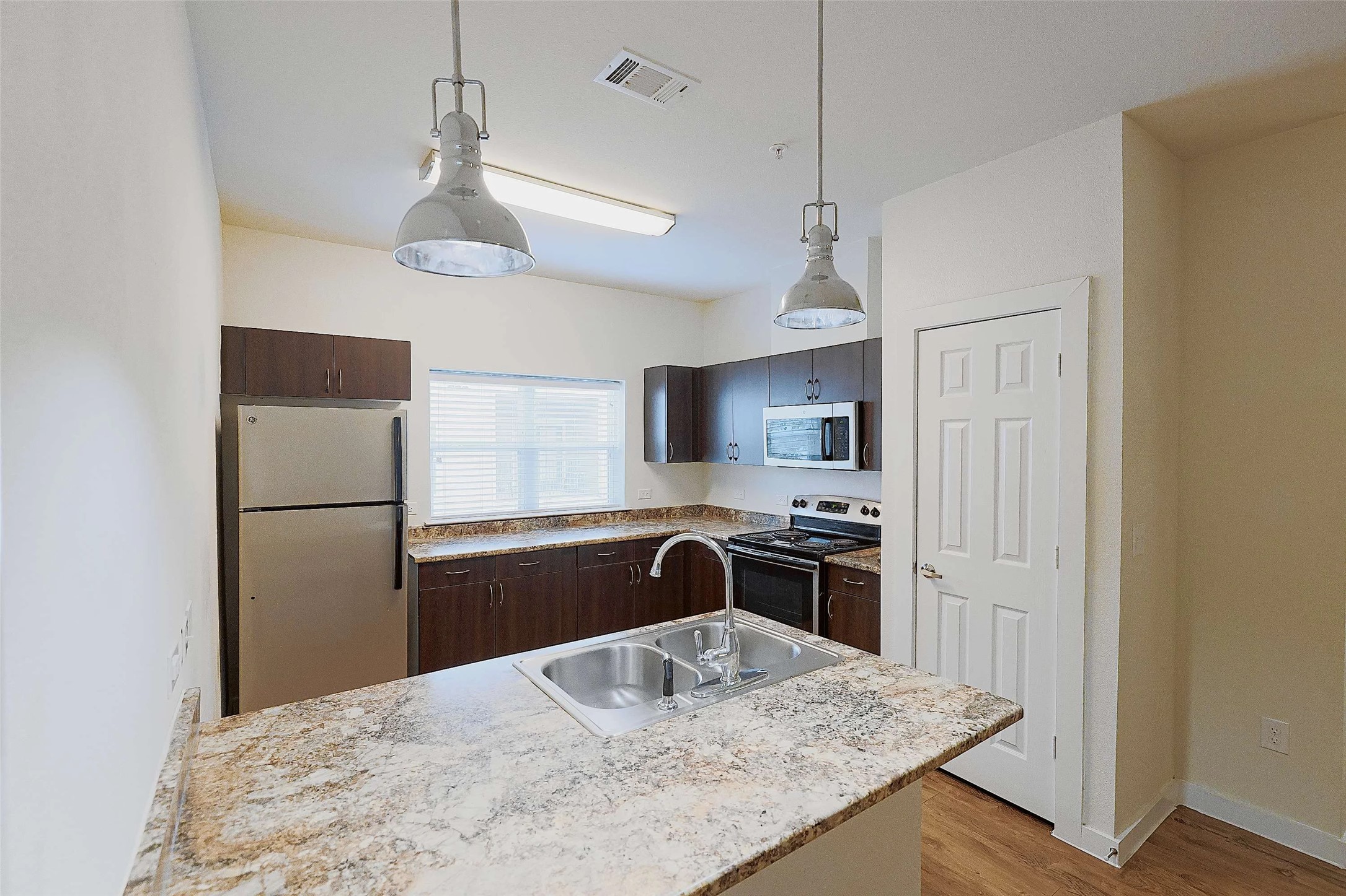 6725 Circle S Road, Unit C1125 Austin, TX 78745 - Photo 12 of 13 a kitchen with stainless steel appliances granite countertop a sink stove and refrigerator