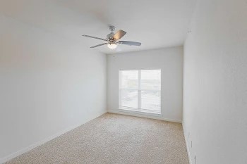6725 Circle S Road, Unit C1125 Austin, TX 78745 - Photo 2 of 13 an empty room with windows and fan