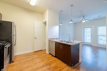 6725 Circle S Road, Unit C1125 Austin, TX 78745 - Photo 5 of 13 a kitchen with stainless steel appliances granite countertop a stove and a refrigerator