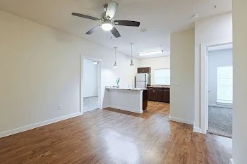 6725 Circle S Road, Unit C1125 Austin, TX 78745 - Photo 6 of 13 a view of a kitchen with wooden floor and a kitchen space with a sink