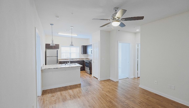6725 Circle S Road, Unit C1125 Austin, TX 78745 - Photo 10 of 13 a view of a kitchen with wooden floor and a sink