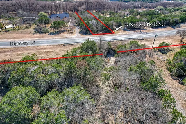 a view of a house with a porch and a tree