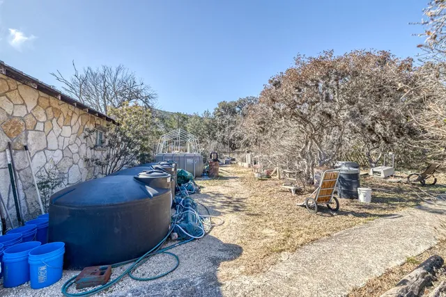 an aerial view of a house with yard and swimming pool