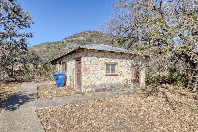 an aerial view of a house with a yard