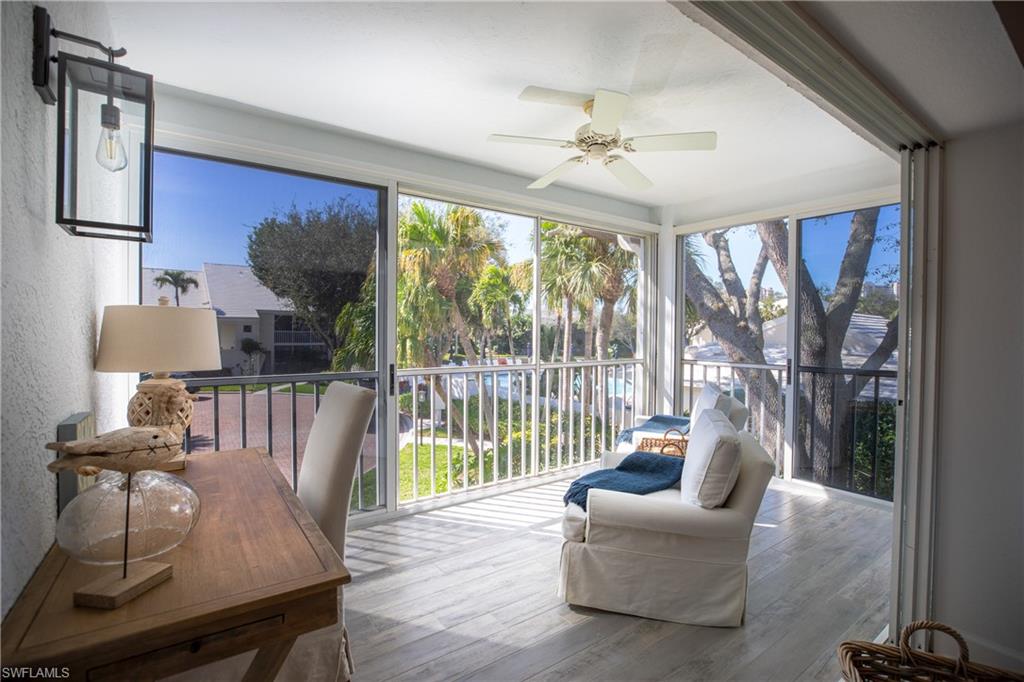 790 Willowbrook Drive, Unit 305 Naples, FL 34108 - Photo 13 of 23 a living room with furniture and a large window