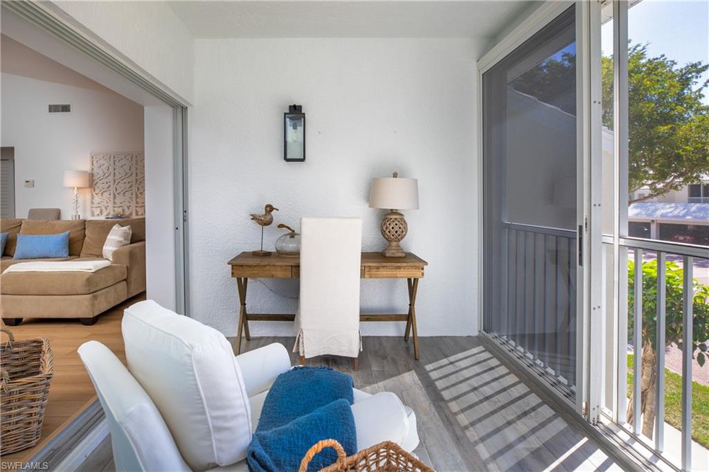 790 Willowbrook Drive, Unit 305 Naples, FL 34108 - Photo 14 of 23 a living room with furniture and a window