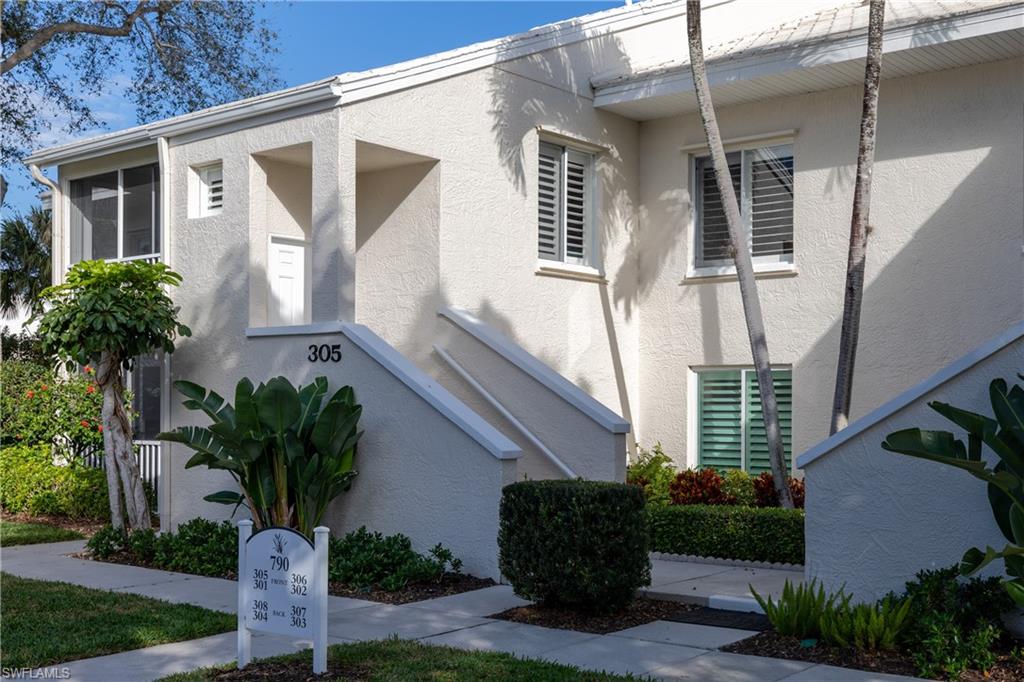 790 Willowbrook Drive, Unit 305 Naples, FL 34108 - Photo 17 of 23 a front view of a house with garden