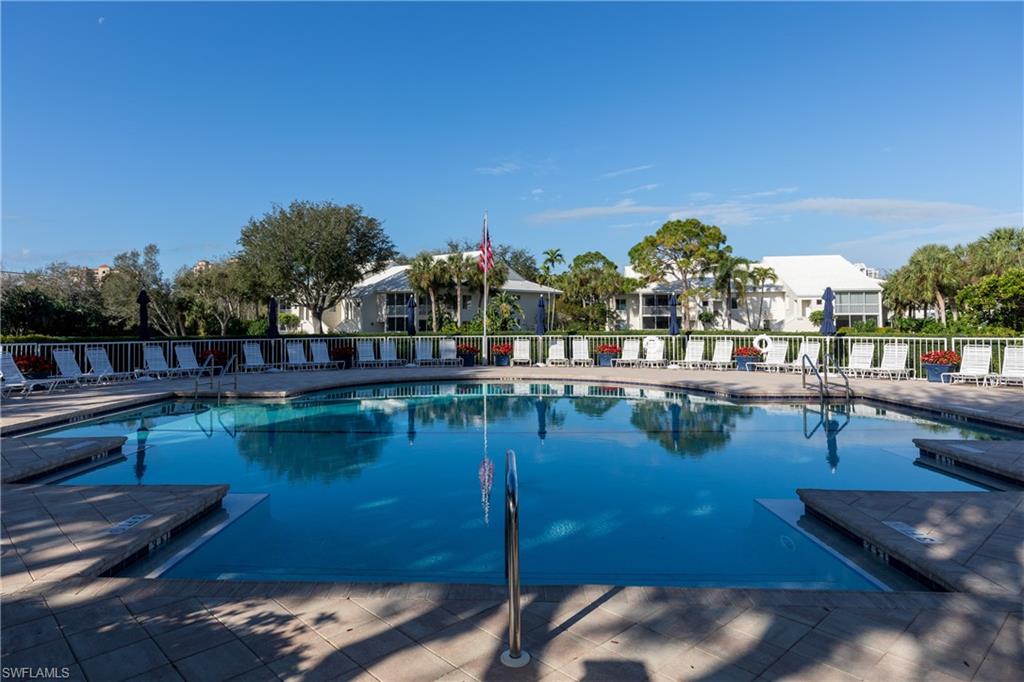 790 Willowbrook Drive, Unit 305 Naples, FL 34108 - Photo 19 of 23 a view of swimming pool with outdoor seating and lake view