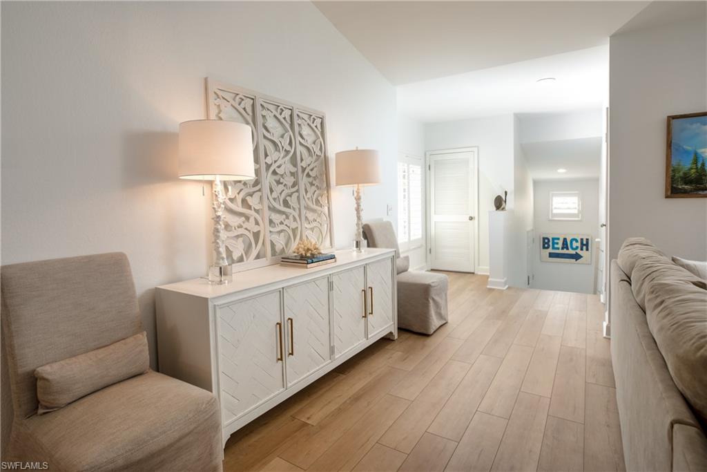 790 Willowbrook Drive, Unit 305 Naples, FL 34108 - Photo 2 of 23 a large white room with mirror and