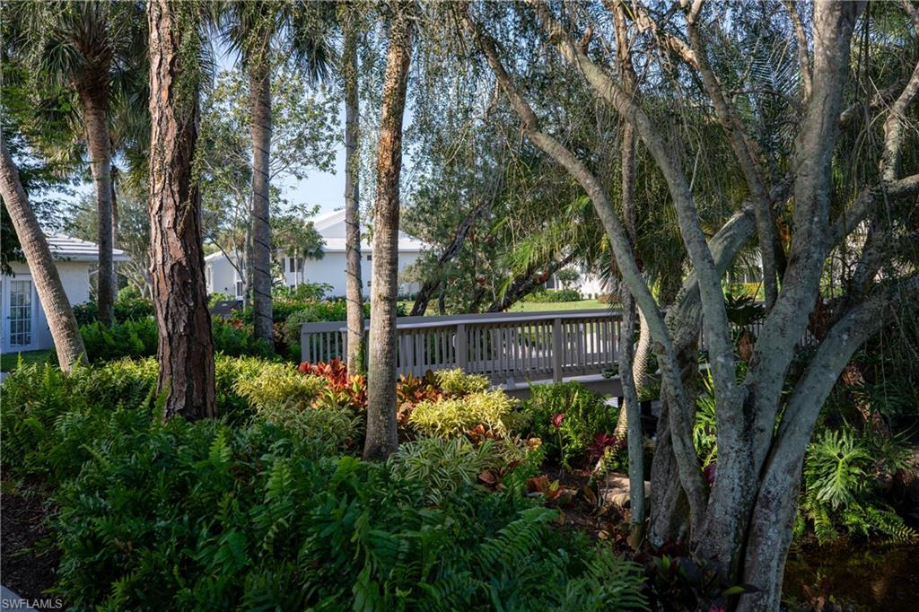 790 Willowbrook Drive, Unit 305 Naples, FL 34108 - Photo 21 of 23 a view of a garden in the backyard