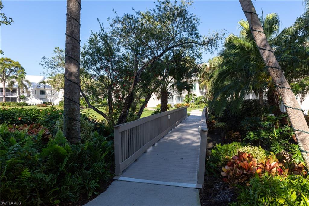 790 Willowbrook Drive, Unit 305 Naples, FL 34108 - Photo 22 of 23 a view of a pathway both side of the house