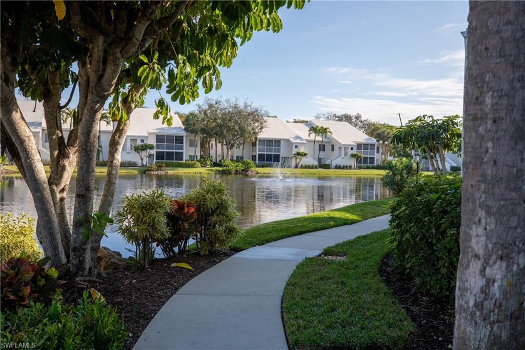 790 Willowbrook Drive, Unit 305 Naples, FL 34108 - Photo 23 of 23 a view of a lake with a house in the background