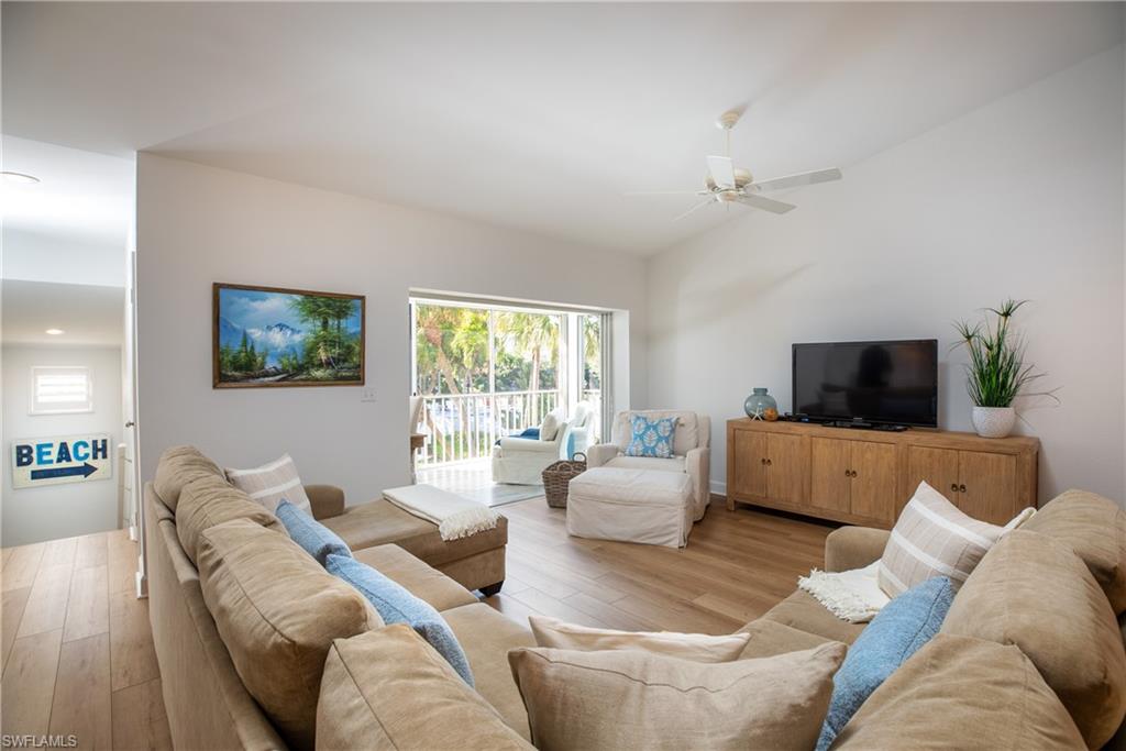 790 Willowbrook Drive, Unit 305 Naples, FL 34108 - Photo 3 of 23 a living room with furniture and a flat screen tv