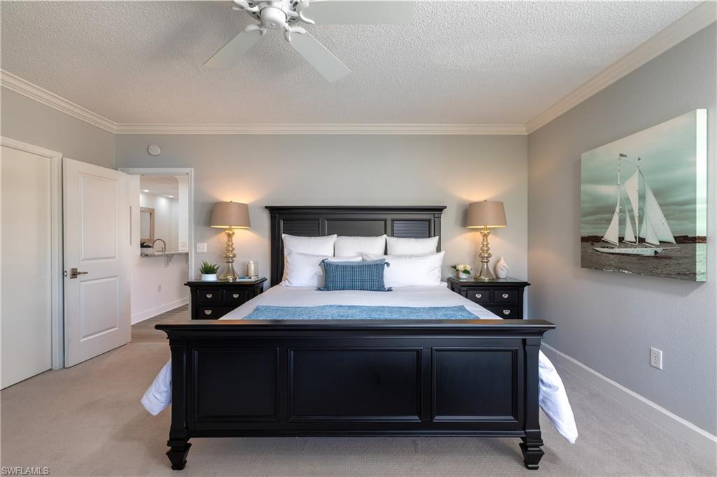 790 Willowbrook Drive, Unit 305 Naples, FL 34108 - Photo 9 of 23 a bedroom with a bed and a table