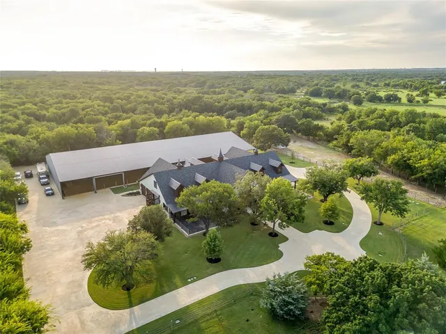 an aerial view of a house with yard