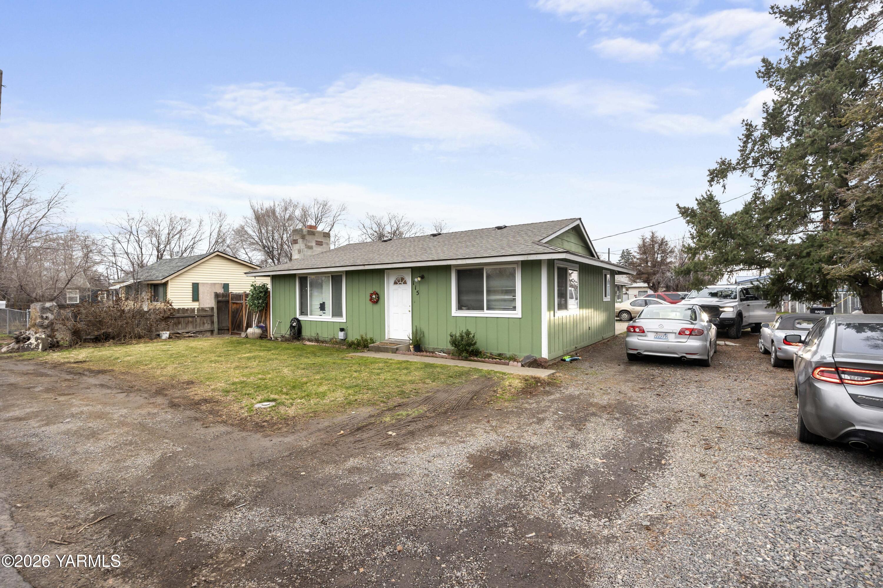 115 East D Street Wapato, WA 98951 - Photo 1 of 28 a front view of a house with a garden and parking space
