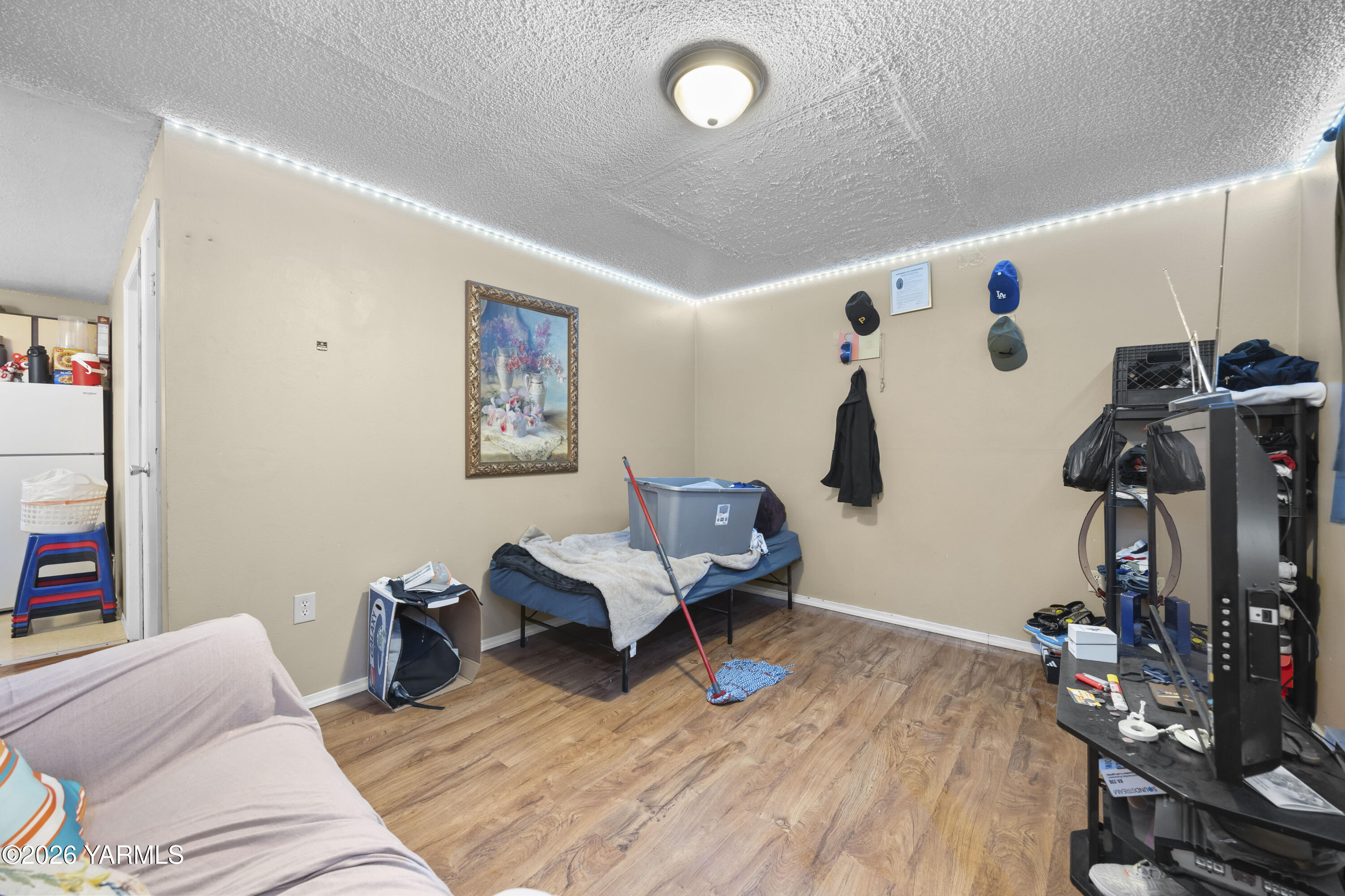 115 East D Street Wapato, WA 98951 - Photo 13 of 28 a living room with furniture and a flat screen tv