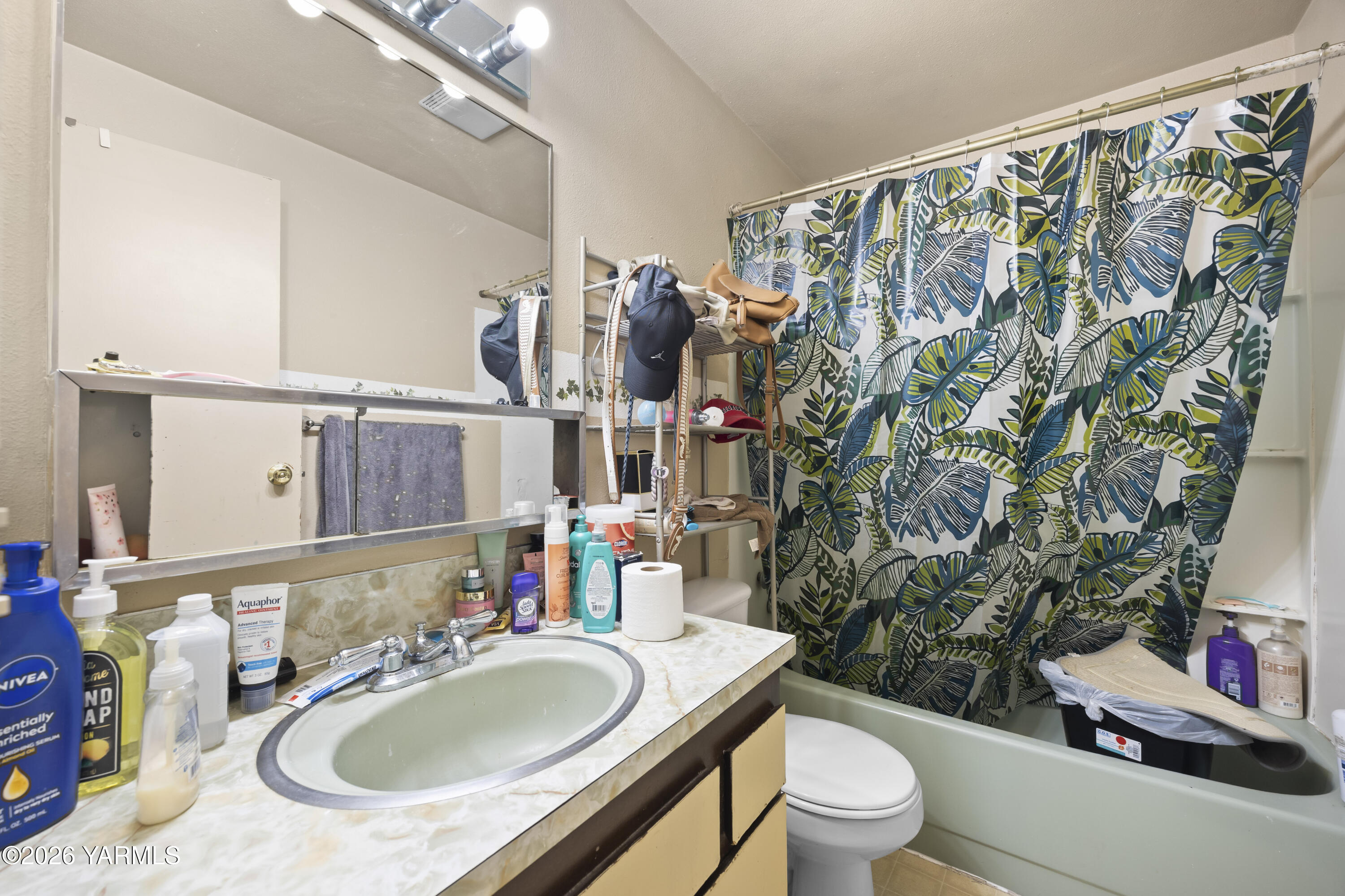 115 East D Street Wapato, WA 98951 - Photo 15 of 28 a bathroom with a granite countertop sink and a mirror