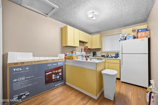 a kitchen with a refrigerator and a stove top oven