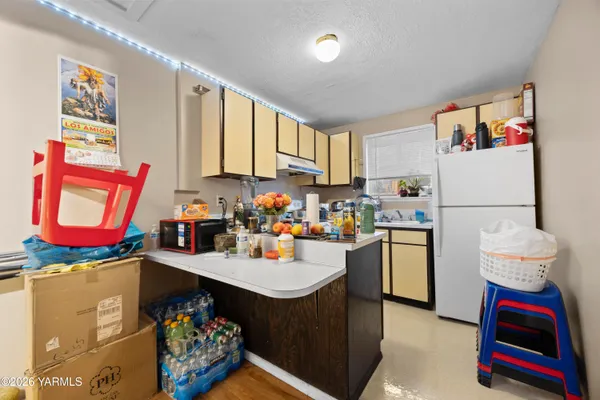 a kitchen with refrigerator and stove