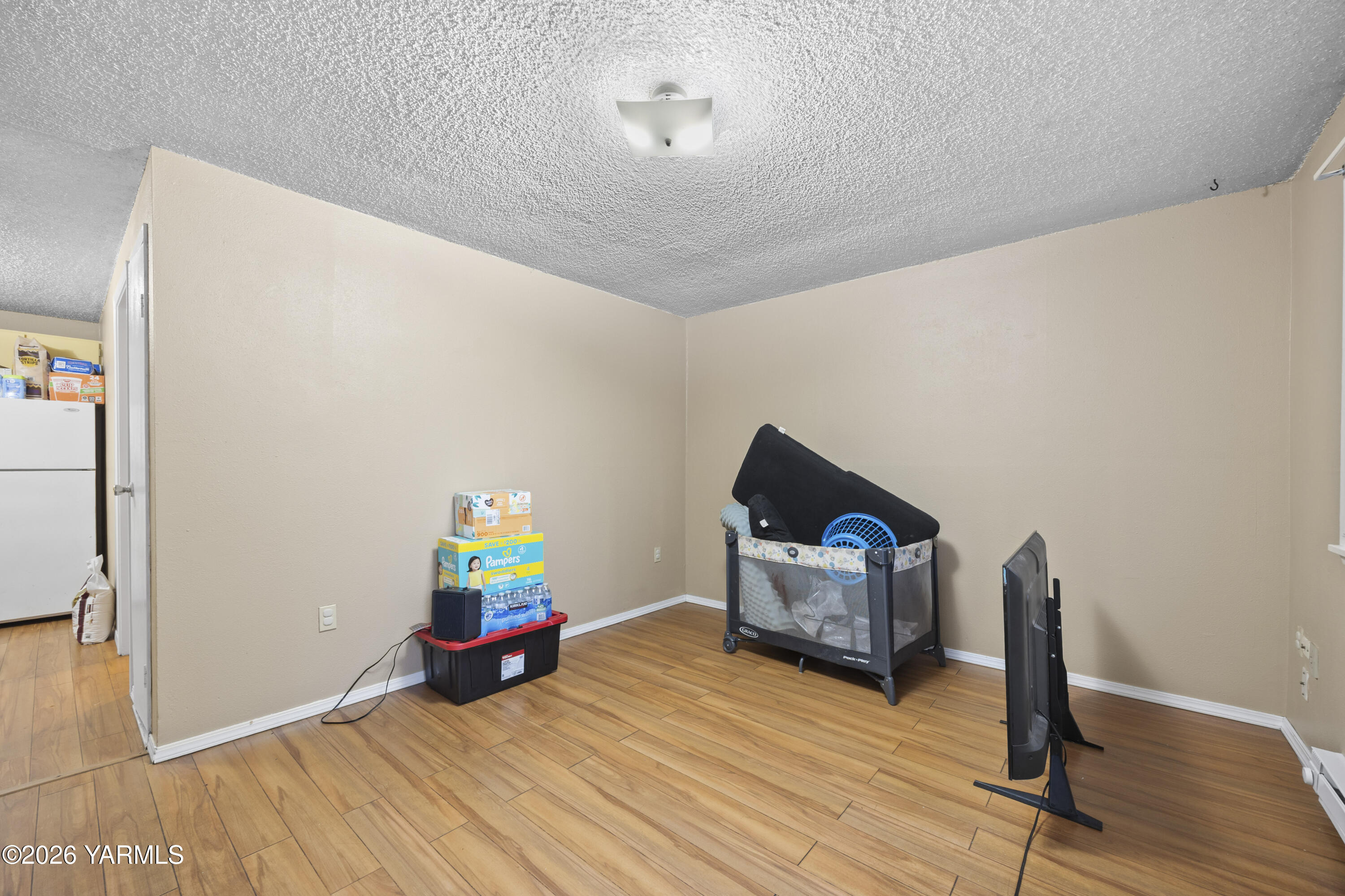 115 East D Street Wapato, WA 98951 - Photo 23 of 28 a living room with furniture and a wooden floor