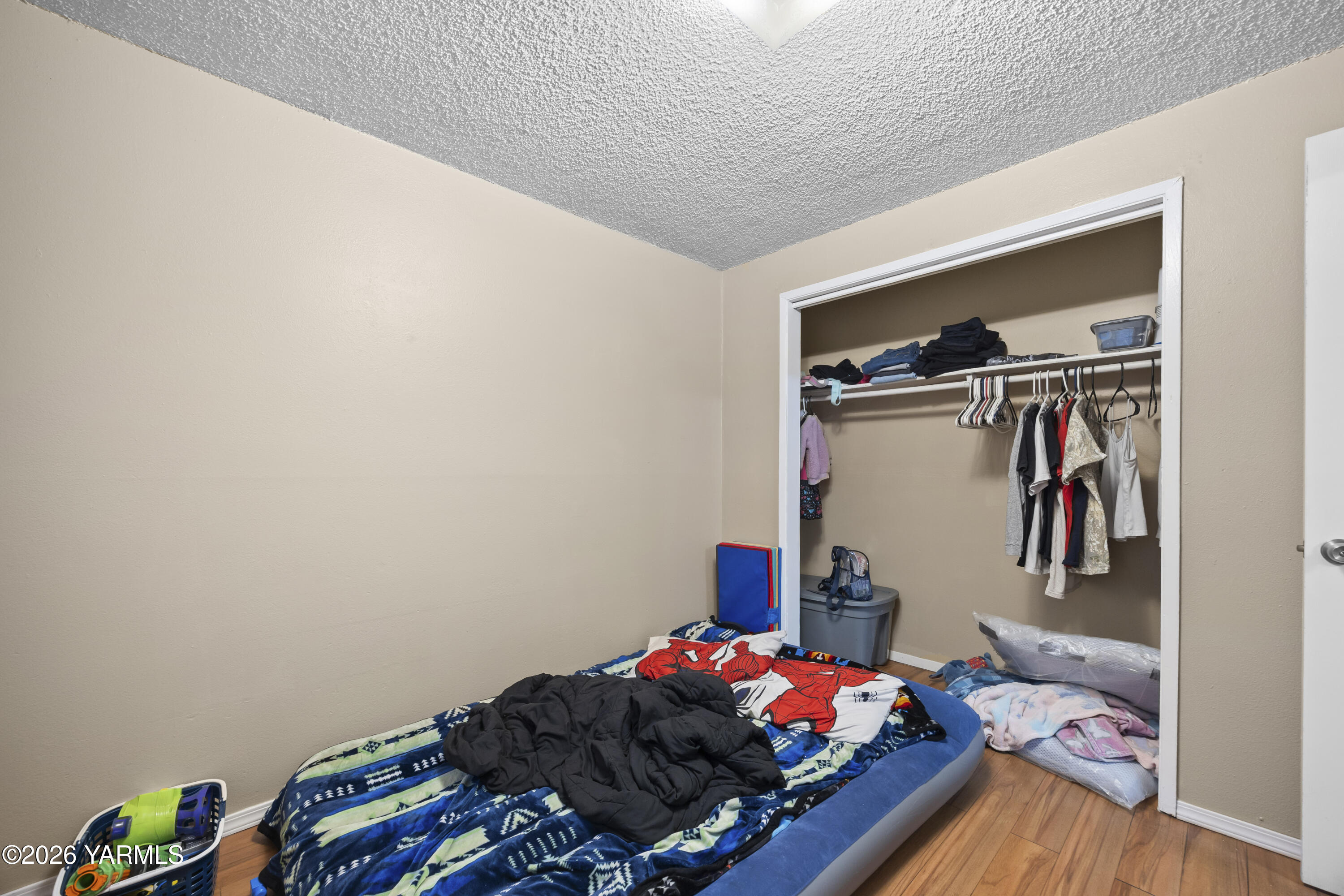 115 East D Street Wapato, WA 98951 - Photo 26 of 28 a bedroom with a bed and a closet