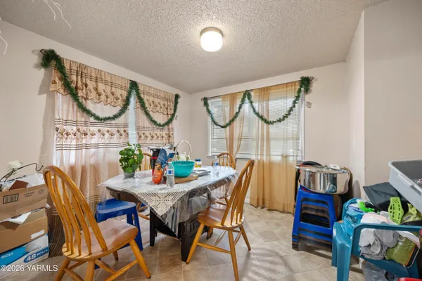 a dining room with furniture and a wooden floor