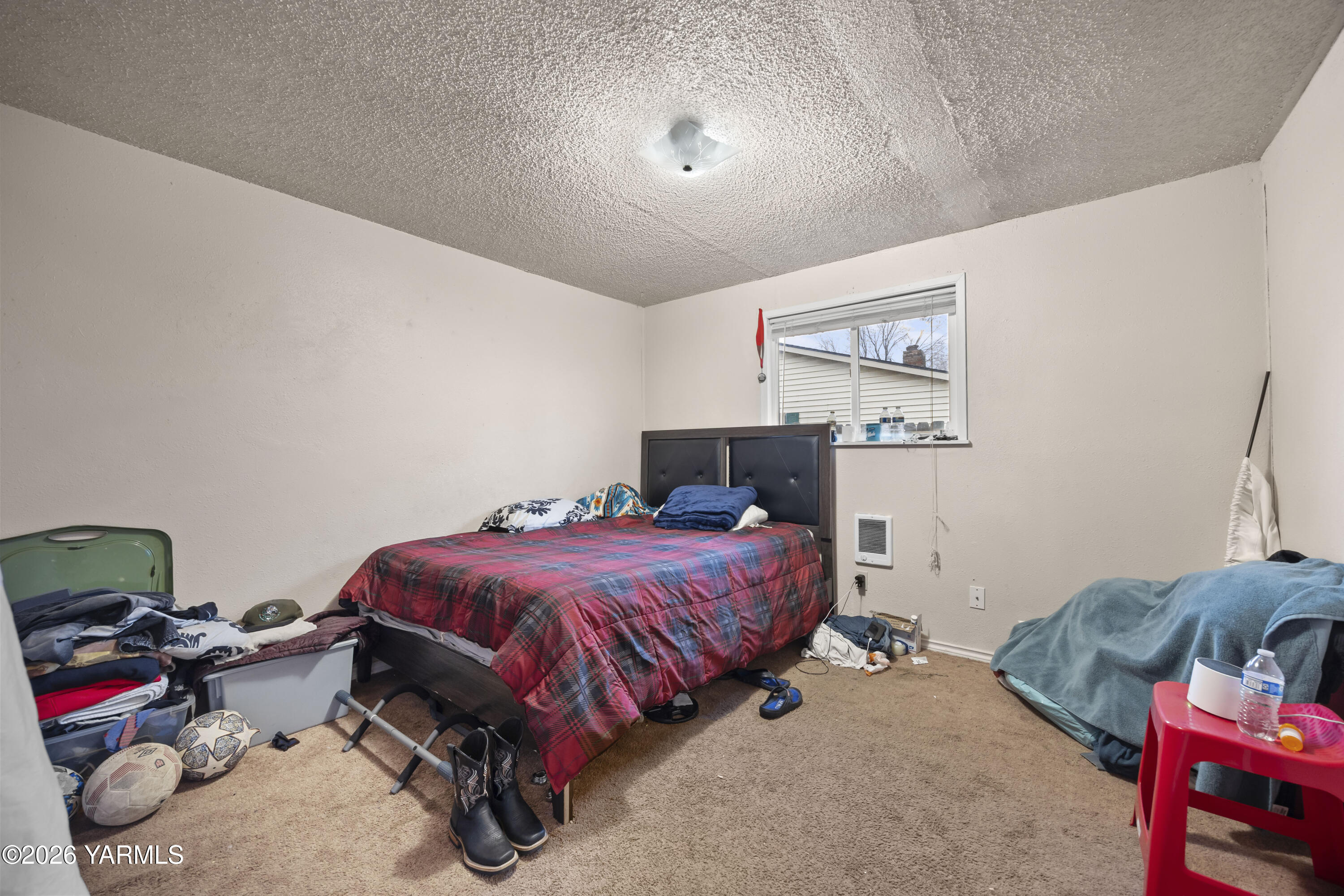 115 East D Street Wapato, WA 98951 - Photo 8 of 28 a bedroom with furniture and a bed