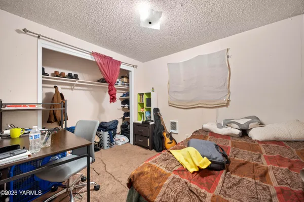 a bedroom with a bed and a desk
