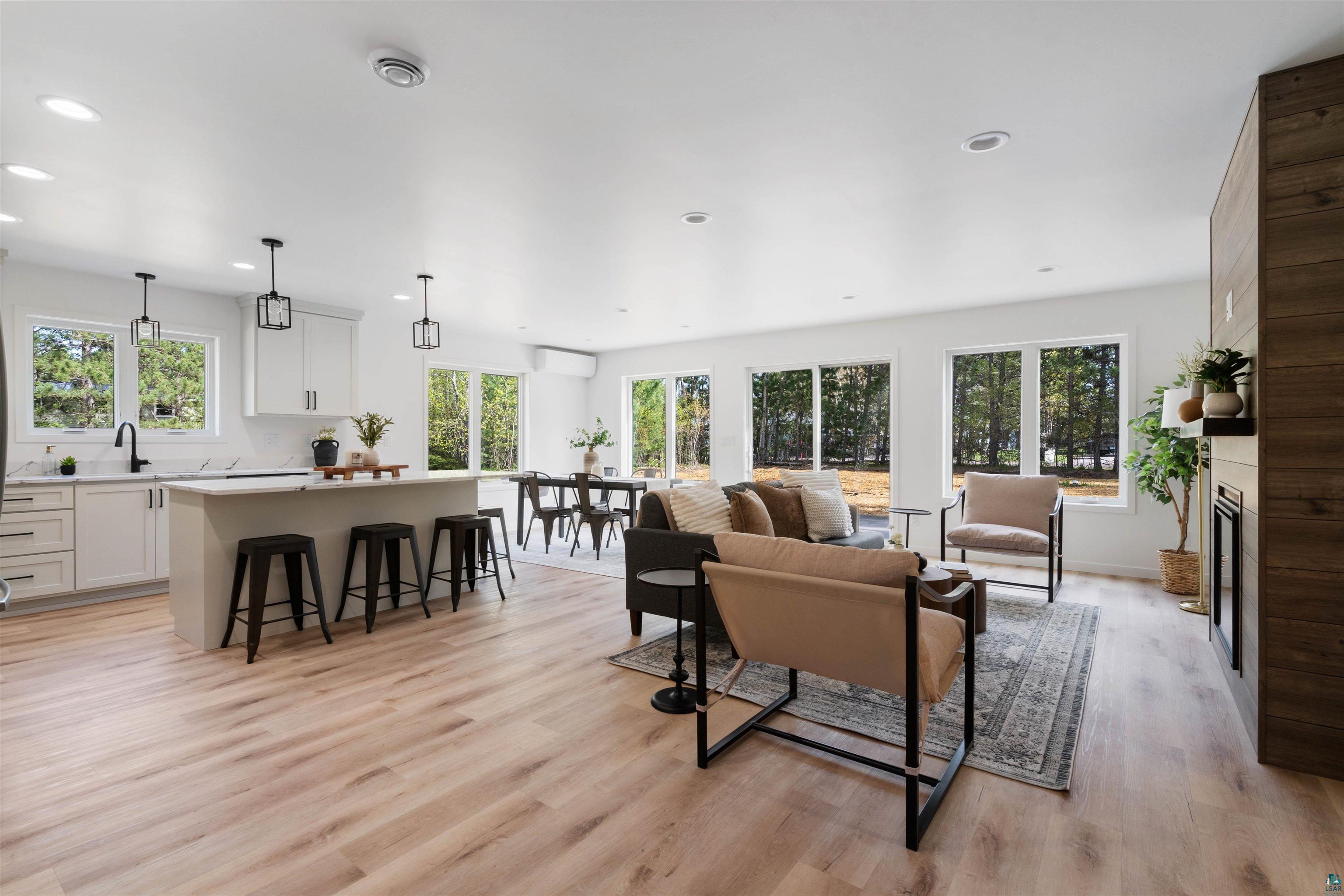 1386 Stephen Road Cloquet, MN 55720 - Photo 14 of 25 Open concept living space featuring wood-finish flooring, recessed lighting, and white walls