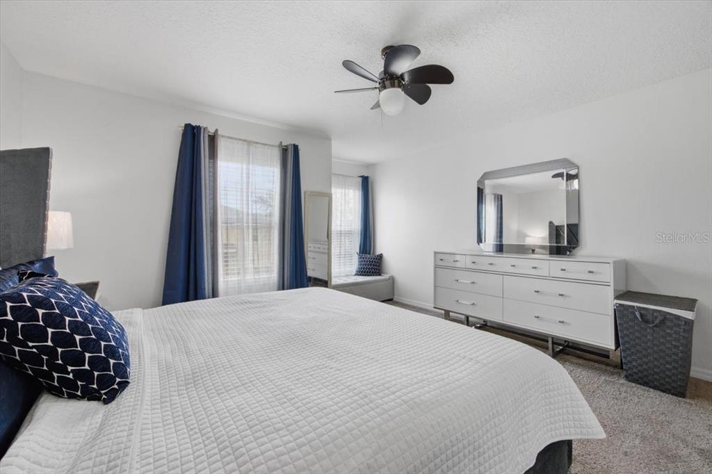 5410 Quarry Rock Road Lakeland, FL 33809 - Photo 15 of 26 a bedroom with a bed and a chandelier