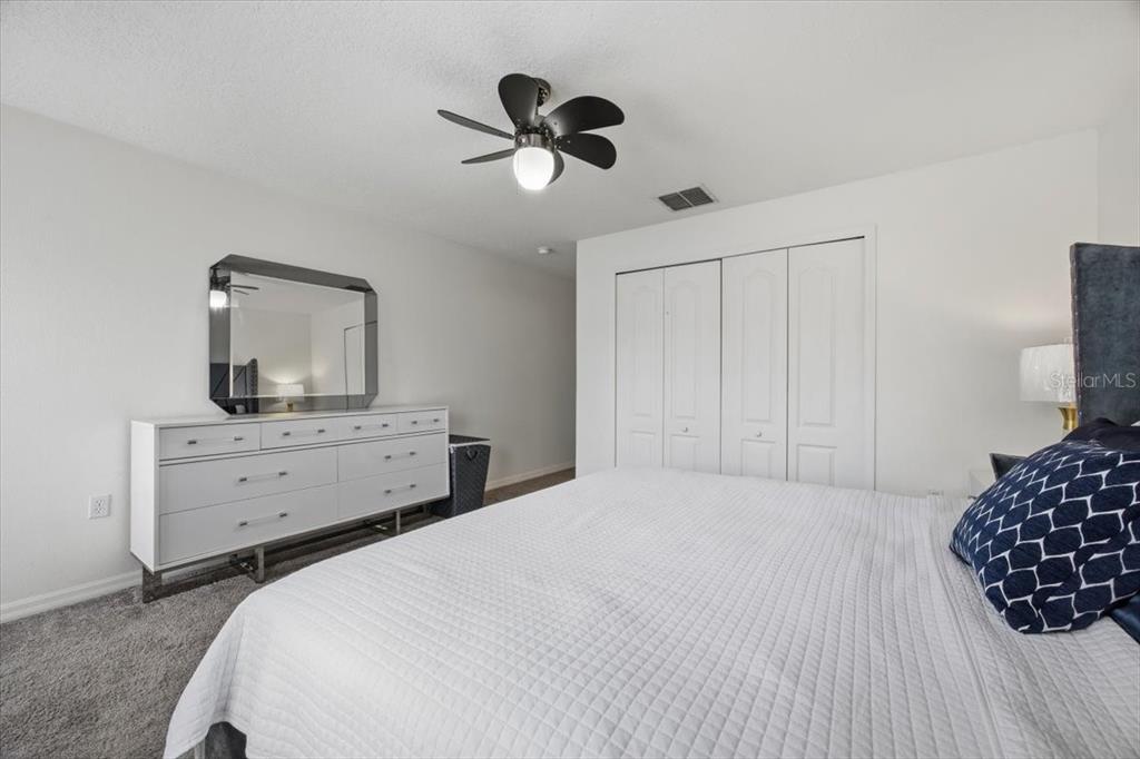 5410 Quarry Rock Road Lakeland, FL 33809 - Photo 17 of 26 a bedroom with a bed and a chandelier