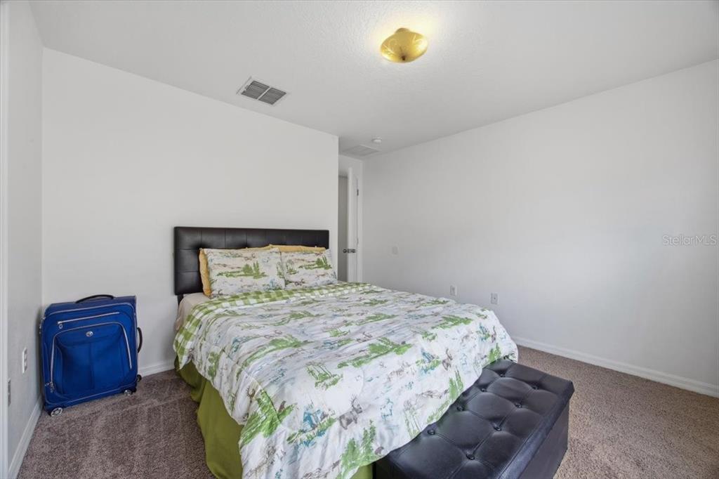 5410 Quarry Rock Road Lakeland, FL 33809 - Photo 20 of 26 a bedroom with a bed and a lamp