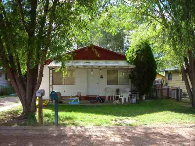 127 June Street Rifle, CO 81650 - Photo 1 of 4 a view of a porch with chairs and a yard
