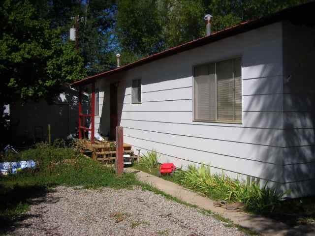 127 June Street Rifle, CO 81650 - Photo 2 of 4 a small garden in the backyard of a house