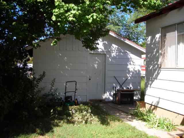 127 June Street Rifle, CO 81650 - Photo 3 of 4 a backyard of a house with table and chairs