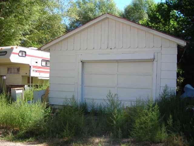 127 June Street Rifle, CO 81650 - Photo 4 of 4 a backyard of a house with plants and large trees