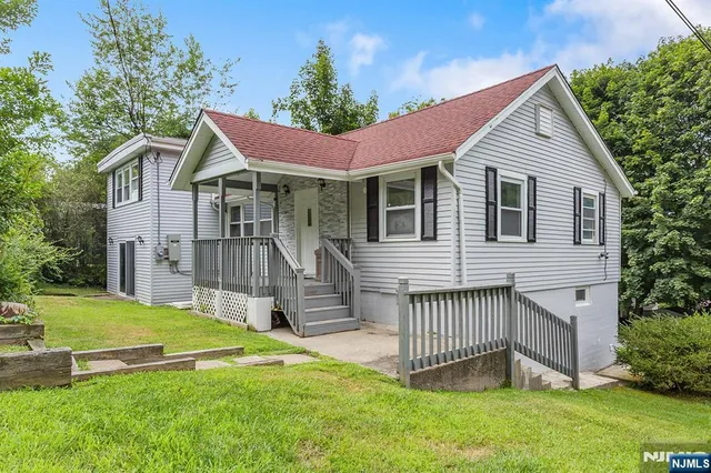 a view of a house with a yard and deck