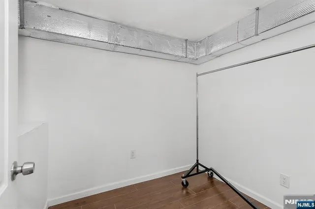 a view of a room with wooden floor