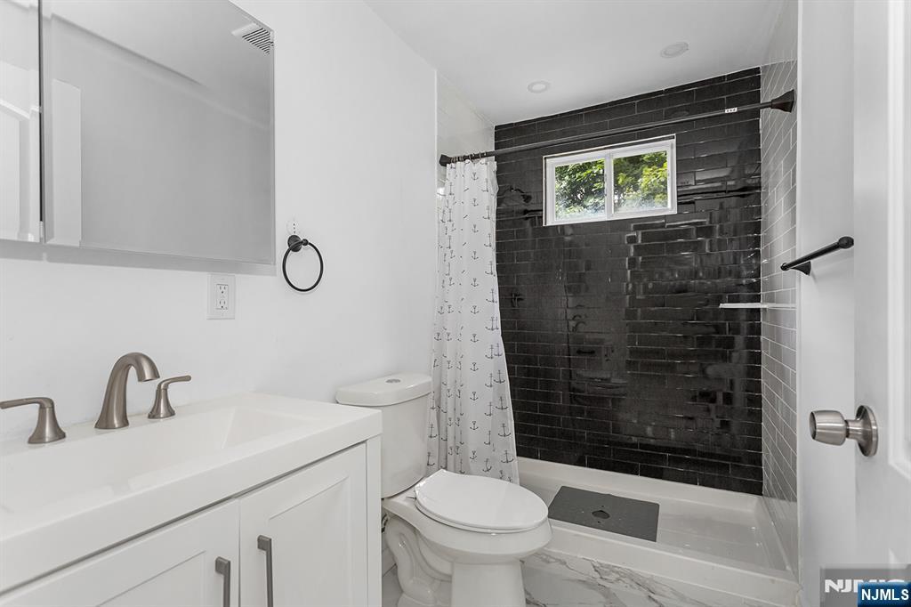 67 Nolans Point Road Lake Hopatcong, NJ 07849 - Photo 25 of 43 a bathroom with a sink toilet and shower