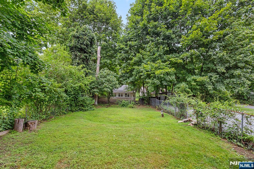 67 Nolans Point Road Lake Hopatcong, NJ 07849 - Photo 29 of 43 a backyard of a house with lots of green space
