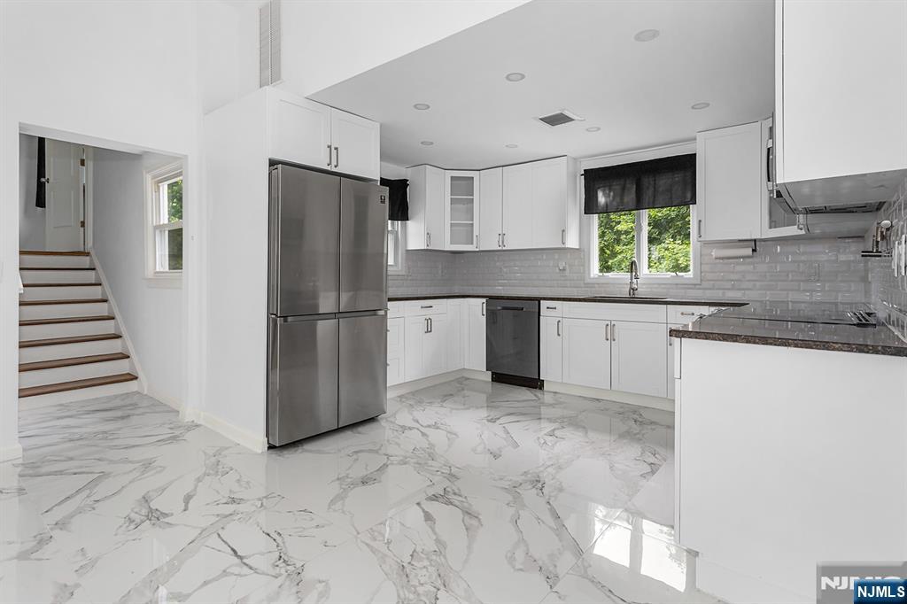 67 Nolans Point Road Lake Hopatcong, NJ 07849 - Photo 7 of 43 a kitchen with granite countertop a refrigerator and a sink